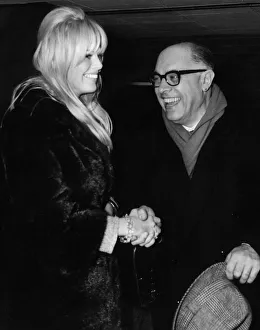 00141 Prints: Carlo Ponti and Britt Ekland met waiting at the luggage bay at London Airport