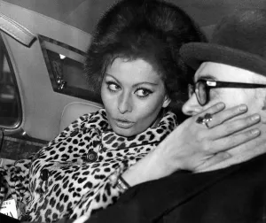 Producers Prints: Carlo Ponti film producer has his cheek stroked by Sophia Loren actress