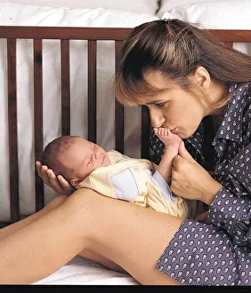 Carol Smillie tv presenter with baby Christie kissing toe