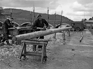 Carpenter Prints: Carpenters seen here making a new mast for a fishing boats moored in the Cornish fishing