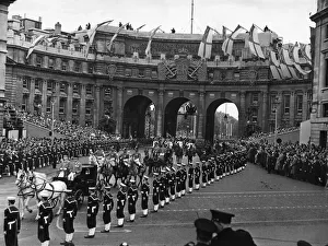 The Carriage Procession of Prime Ministers passes underneath Admiralty Arch as it makes