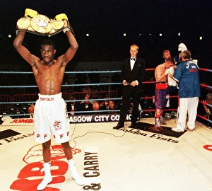 00200 Prints: Cassius Baloyi lifts the WBU featherweight championship belt June 1999
