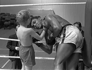 Fitness Prints: Cassius Clay with 6 year old Patrick Power in the ring during his training for