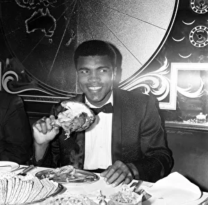 Portrait Posed Prints: Cassius Clay (Muhammad Ali) eating chicken at Isows restaurant in Soho Brewer Street