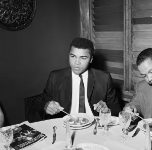 Cassius Clay (Pictured) having lunch in London before his trip to Scotland for an