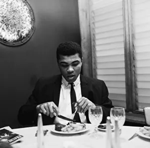 01013 Prints: Cassius Clay (Pictured) having lunch in London before his trip to Scotland for an