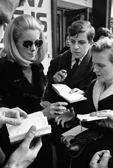 Catherine Deneuve march 1966 Signs autograph while leaving the theatre after