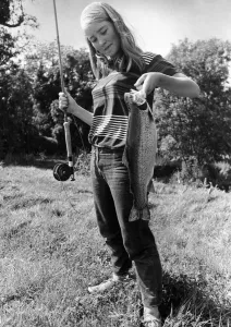00087 Prints: Celia Reade, aged 14 seen here shortly after landing a trout following a fishing lesson