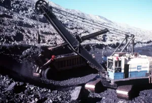 Air Pollution Prints: Nine centimetre bucket filling 110 tonne haul unit with black coal at Ravensworth mine