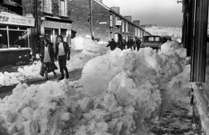 Snowing Prints: In the centre of town, Treharris, there is a pile-up confronting hardy pedestrians