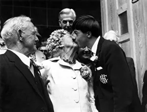 After the ceremony, 78-year-old bridegroom Herbert Clear watches as Philip Ealey gives