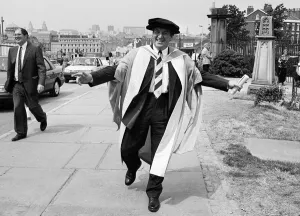 University Prints: Former chairman of Next George Davies, shows off his robes for the degree ceremony of