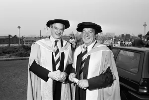 Former chairman of Next George Davies, shows off his robes for the degree ceremony of