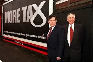 Images Dated 1st March 1999: Chancellor Gordon Brown March 1999 with Donald Dewar pointing at poster about SNP
