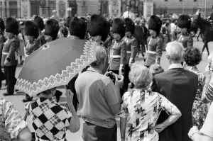 Guard Prints: Changing of the Guard in London today. An umbrella serves as a sun-shade for a spectator