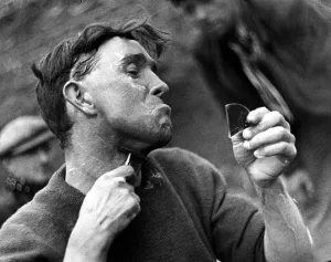 Character Studies. Man shaving using razor and broken piece of mirror P044416