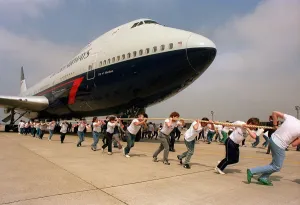 Charity Aircraft Pull. A British Airways Boeing 747 Jumbo Jet is pulled along the tarmac