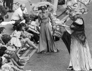 00447 Prints: Charity collectors in Ascot racegoers outfits with outlandish hats charm the crowds