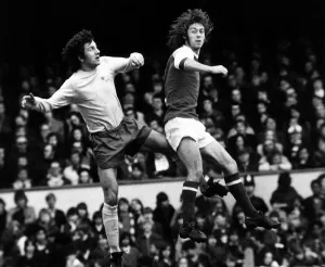 00241 Prints: Charlie George Football Player March 1973 jumps with Roy McFarland for the ball