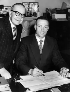 Contract Prints: Charlie Mitten signs the agreement to become the new manager of Newcastle United watched