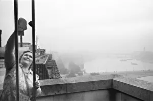 Dusting Prints: Charwoman at the Savoy seen here cleaning the windows of a suite that overlooks the River