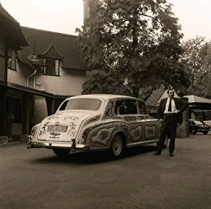 The chauffeur of The Beatles singer John Lennon standing beside Lennon