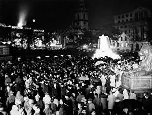 Cheers in the rain. Thousands jammed Trafalgar-square as the rain poured down last night