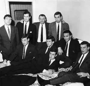 Chelsea FC Manager Tommy Docherty puts his hands on the shoulders of two of the eight