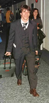 Suitcase Prints: Chelsea and Italy footballer Gianfranco Zola arriving at Heathrow airport after England