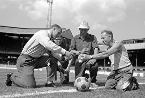 Superstition Prints: Chelsea manager Tommy Docherty christens the centre spot of the Stamford Bridge pitch
