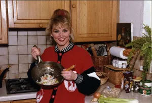 Cheryl Baker former Bucks Fizz singer and TV presenter cooking a stir fry in her kitchen