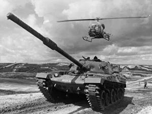 A Chieftan tank of the Royal Amoured Corp seen here on exercise with a army helicopter