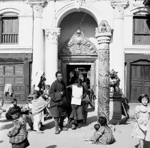 Buddhism Prints: Child beggars gather around an entrance to a temple in central Katmandu, Nepal