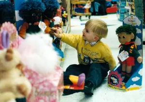 Toddler Prints: Child, Lewis Cromby aged 3, explores Bendy Soft toy during pre christmas shopping trip