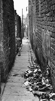 Alley Prints: Child playing in alleyway at rear of Gordon Street and Elias Street, Toxteth, Liverpool