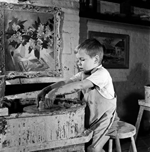Pottery Prints: A child at the pottters wheels at David Rawnsleys Chelsea Studio