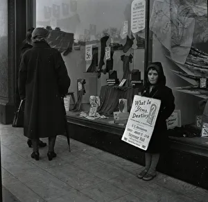 Window Shopping Prints: Child standing outside a shop with a poster advertising a religious meeting