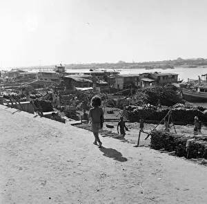 Cargo Prints: A child watches the boats unloaded in Dacca, Bangladesh. February 1961 l