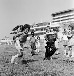 Grandstand Prints: Children carrying their partners on their backs during a horse and jockey style egg