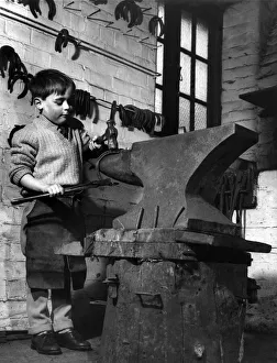 00079 Prints: Children: Clever: He just forging ahead: A big job for a small lad