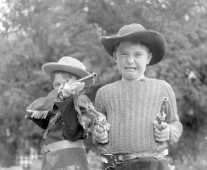 Cowboy Prints: Children dressed & playing Cowboys 29th August 1956. Local Caption Cowboys
