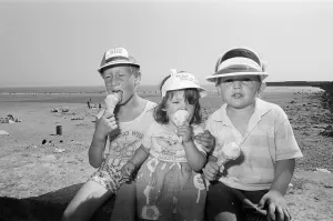 Cone Prints: Children enjoy an ice cream as they try to keep cool on Coney Beach in Porthcawl