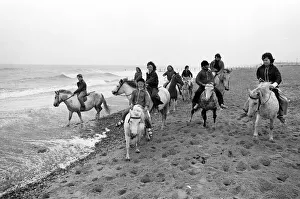 Ponies Prints: Children enjoying a seaside canter on the ponies despite the weather at Hornsea