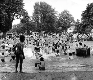 Children enjoying the sunshine having fun in the Victoria Park pool, Cardiff