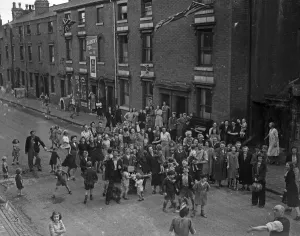 Children, Mums and Dad celebrate VJ Day on the streets of Birmingham 15th August 1945