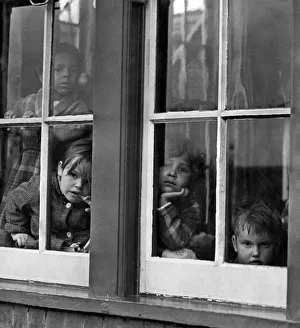 Children: Nurseries. Some of the children looking out of a window at the childrens