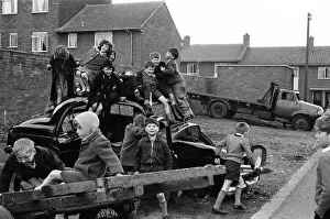 Images Dated 20th July 2021: Children play on the wreck of a dumped car at Kirkby, Liverpool. 18th March 1965
