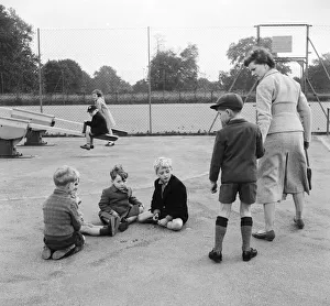 Naughty Prints: Children in the playground playing a game of marbles as one boy is dragged away by his