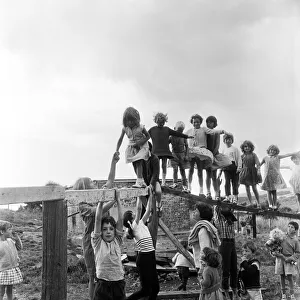 00585 Prints: Children playing on climbing frames at the adventure playground in Moulsecomb, Brighton