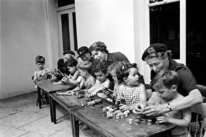 00017 Prints: Children playing with cotton reels at Hollyshaw Residential Nursery